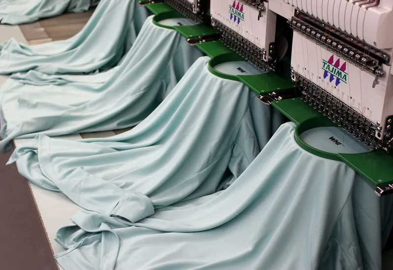 Multi-head embroidery machines running one job across every head