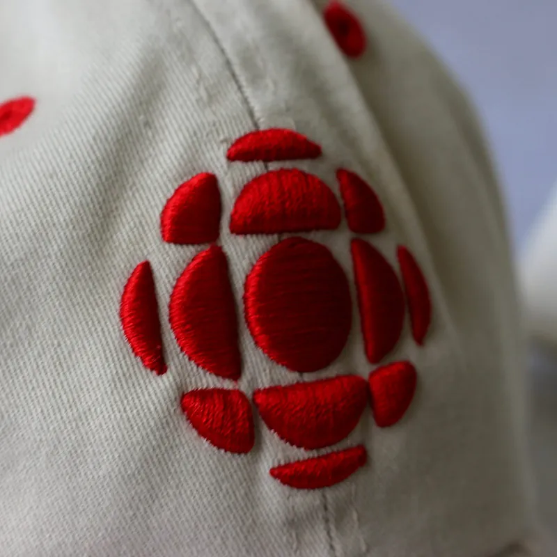 Close-up of an embroidered logo on the front of a cap