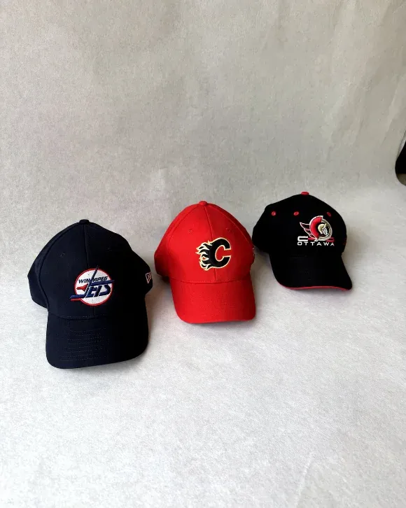 Three team caps with raised front embroidery