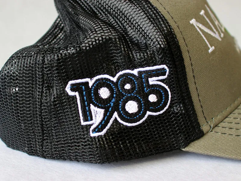 Trucker cap with raised embroidered lettering