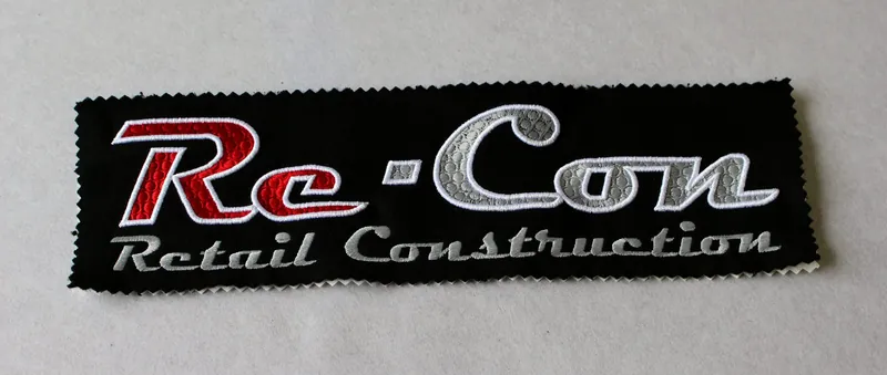 Black patch with red and silver script logo